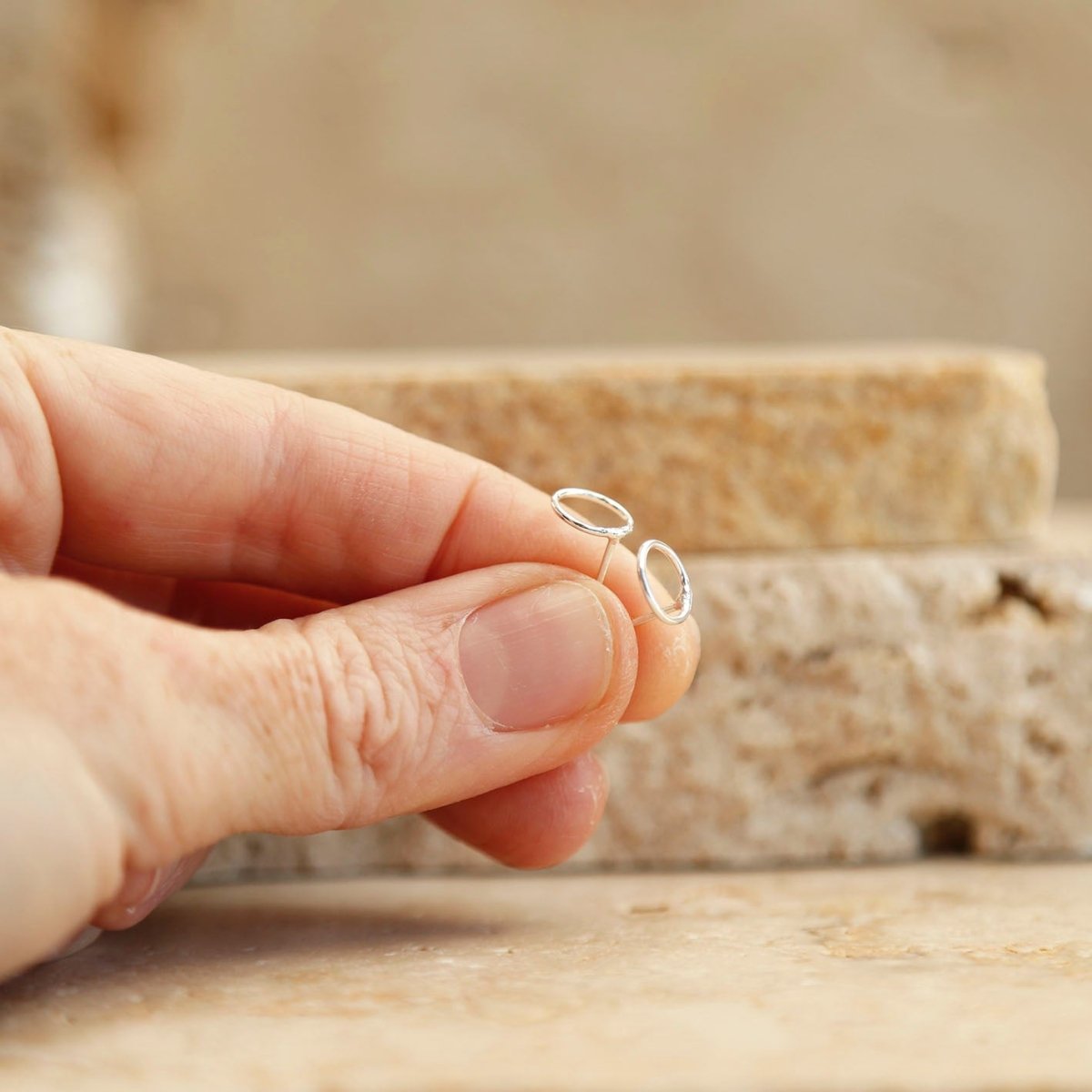 holding sterling silver circle studs